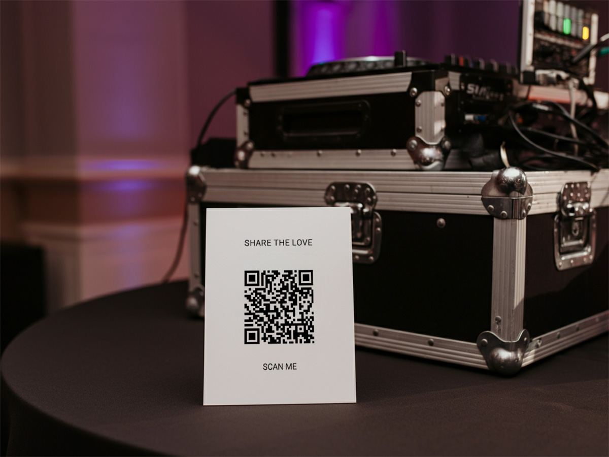 Wedding QR Code card next to dj rig at a wedding